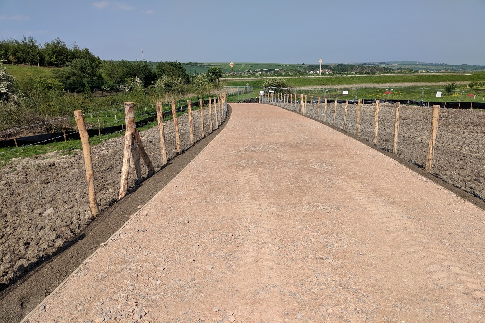 Construction of flood bund across fields between the A26 and an energy recovery facility