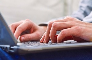 Close up of hands using laptop