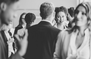 Black and white photo of a group of people networking