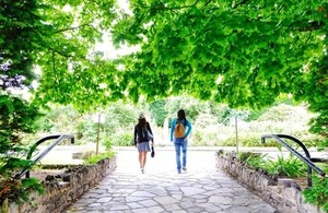 Two women walk through the botanical garden in Belfast via Dignity100 at Shutterstock