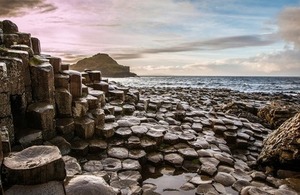 Sunset at Giants Causeway via Pocholo Calapre at Shutterstock