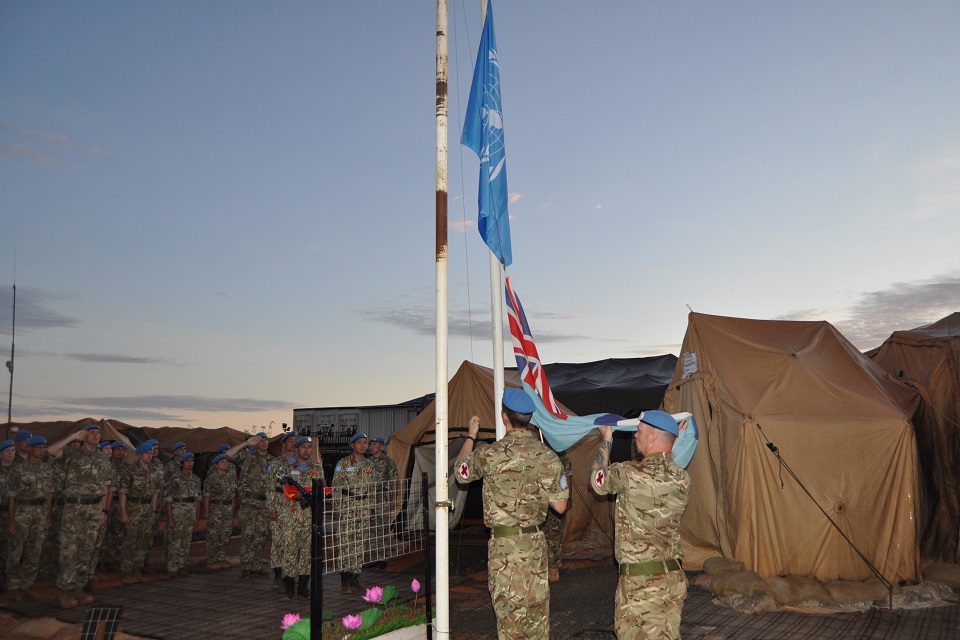 British personnel take down a flag as they hand over the hospital to their Vietnamese partners.