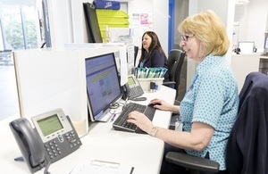 Female receptionists working at a desk.