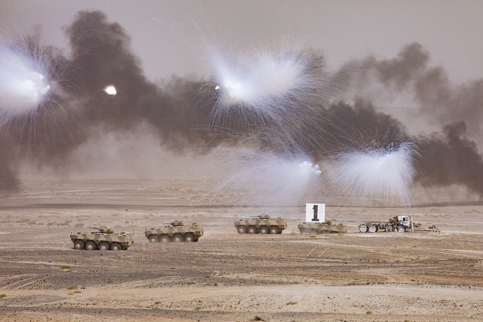 Omani tanks move towards a target, with smoke coming from missiles fired by UK and Omani forces during the Exercise Saif Sareea 3 Firepower demonstration.