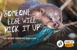 Image of an otter carrying a plastic bag