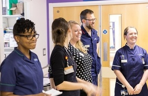 Doctors and nurses chatting in a hospital corridor.