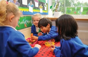 Primary school children sitting around a table