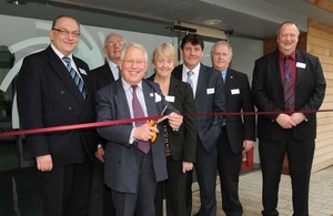 Bob Neill cutting a ribbon