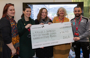 Representatives from Maggie's Swansea including Leon Britton of Swansea City Football Club accept the cheque from DVLA Chief Executive Julie Lennard