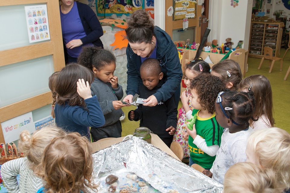Group of nursery children with childcarer