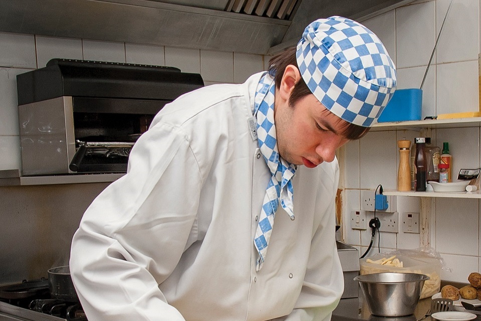 Catering student working in kitchen
