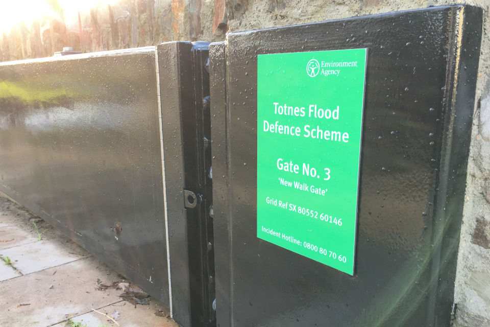 One of the black, metal flood gates swung open