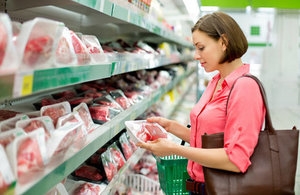 Woman selecting meat at supermarket