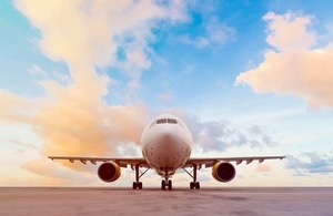 Commercial aeroplane on a runway via tratong at Shutterstock