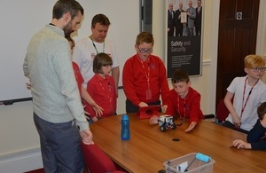 Youngsters work on their presentation as LLWR staff look on.