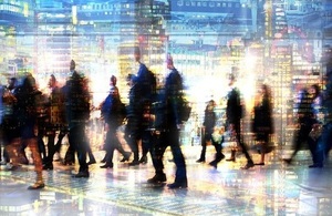 Blurred figures walking through a blurred London landscape
