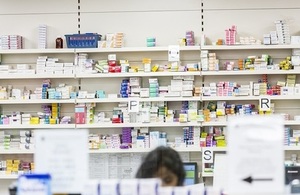 Prescription medications on pharmacy shelves.