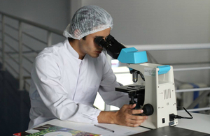 Scientist working at a microscope