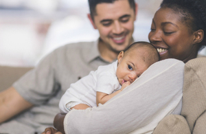 Parents with a young baby (credit: FatCamera/iStock - ID 901666764)