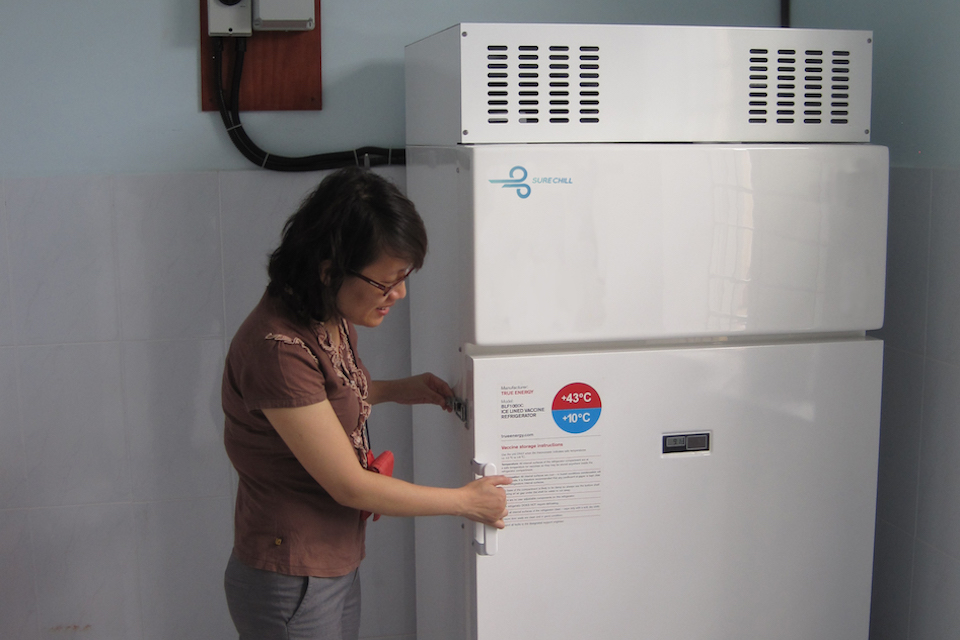 A woman opens a SureChill fridge