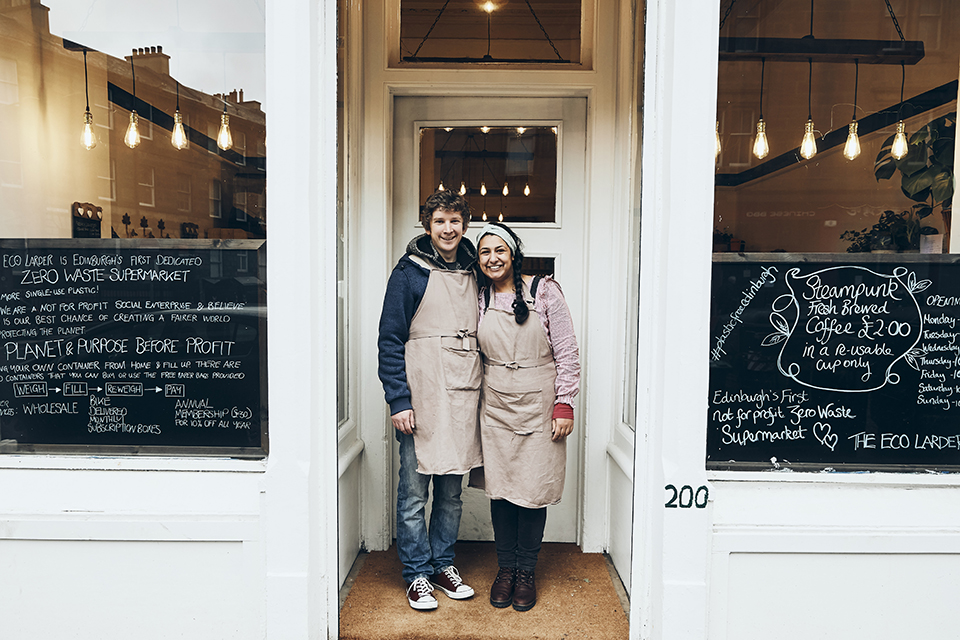 Matthew and Stephanie, directors of the Eco Larder, standing together outside their shop.