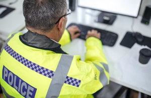 Police officer using a computer