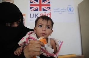 A woman feeds a malnourished child with therapeutic food in Yemen, September 2018