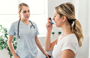 Doctor providing patient with asthma inhaler