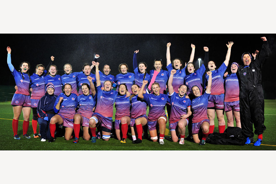 British Police Women’s Rugby team all looking at the camera cheering. 