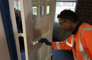 M6 worker painting a door at Tillington Manor school