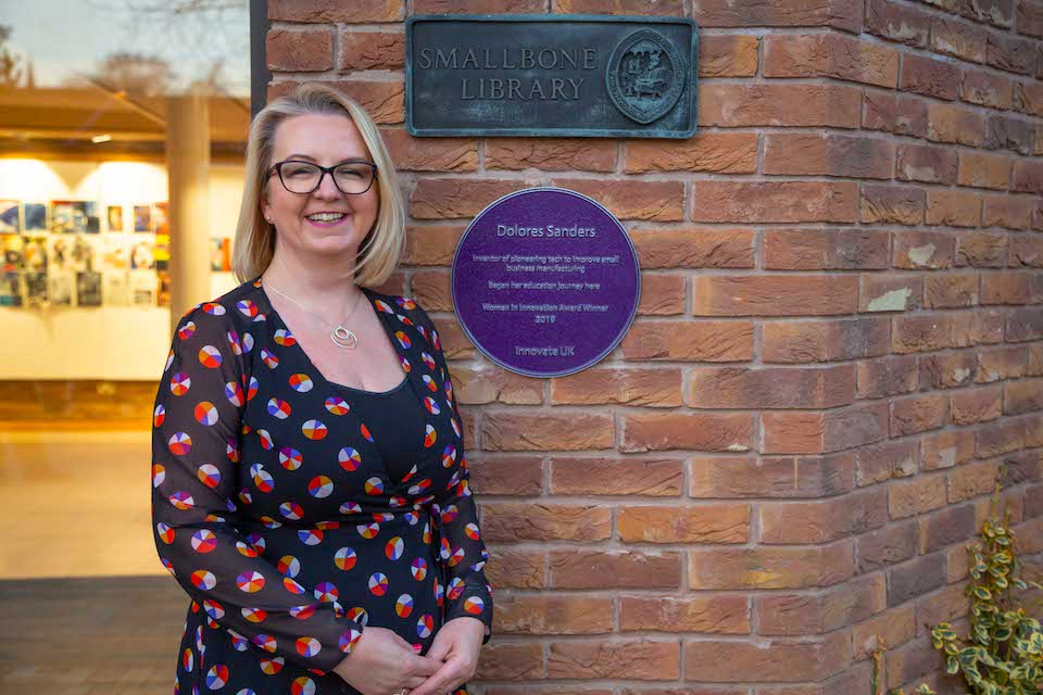 Dolores Sanders, Strategic Director of Total Control Pro Ltd, with her commemorative purple plaque.