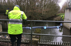 Environment Agency Officers have installed booms to contain the oil