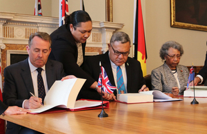 The International Trade Secretary signs a trade continuity agreement alongside the High Commissioners of Fiji and Papua New Guinea