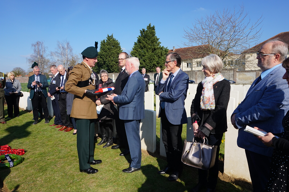 Brigadier Mike Murdoch, Deputy Colonel of The Royal Irish Regiment, presents a Union Flag to the family of Captain Harvey. MOD Crown Copyright.