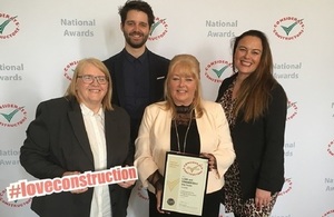 Four smiling colleagues from LLWR and GRAHAM pose with their certificate after winning a Gold Award