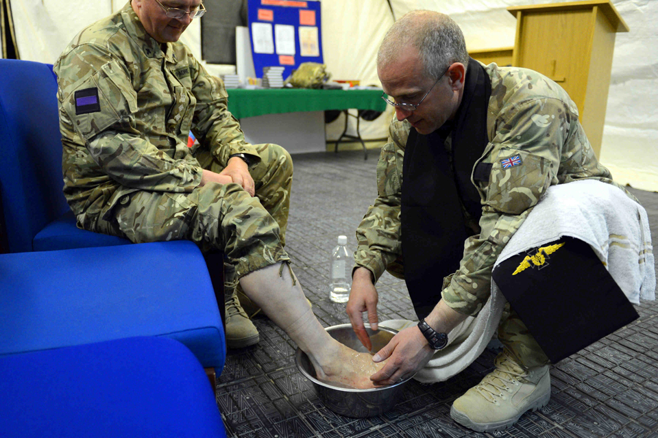 Reverend (Flight Lieutenant) Matt Buchan washes the feet of a serviceman