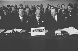 Black and white image of senior officials at a NATO meeting.