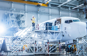 An image of a workman inspecting an airplane.