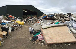 Exterior shot of a warehouse overflowing with rubbish
