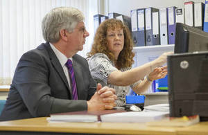 Image: 2 people looking at a computer