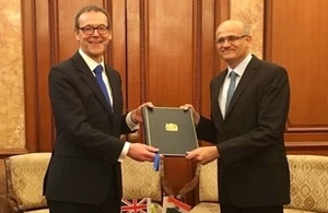Sir Simon Mcdonald presenting signed instrument of ratification to Mr. Gokhale