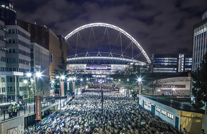 Image of Wembley stadium and famous arch at night time