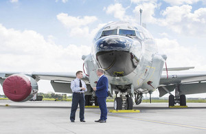 Defence Minister Stuart Andrew and an RAF officer standing in front of a military aircraft