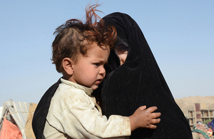 An Afghan woman and child at a camp for displaced people near Baghdis, 2018. Picture: OCHA / Philippe Kropf
