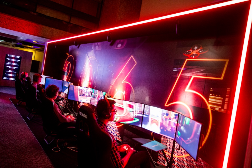 People looking a number of screens
