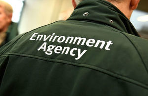 Closeup of the logo on the back of an Environment Agency officer 's uniform