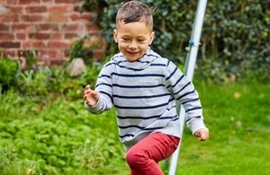 Young boy playing in garden