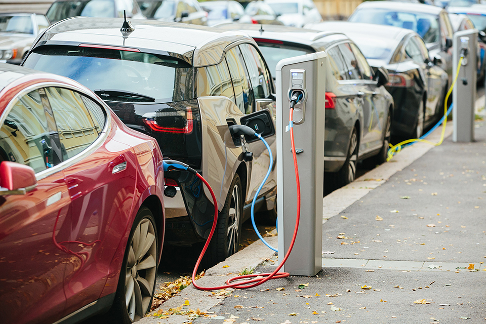 Electric vehicles being charged on the road using electric vehicle chargepoints