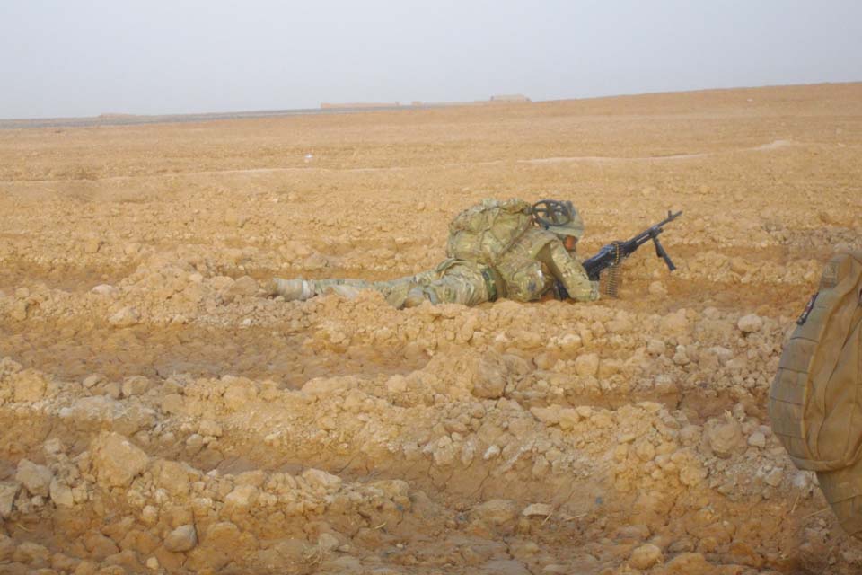 A British soldier takes cover