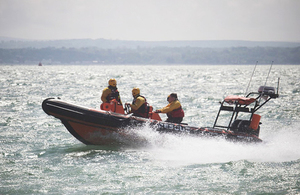Rescue boat with crew in coastal waters